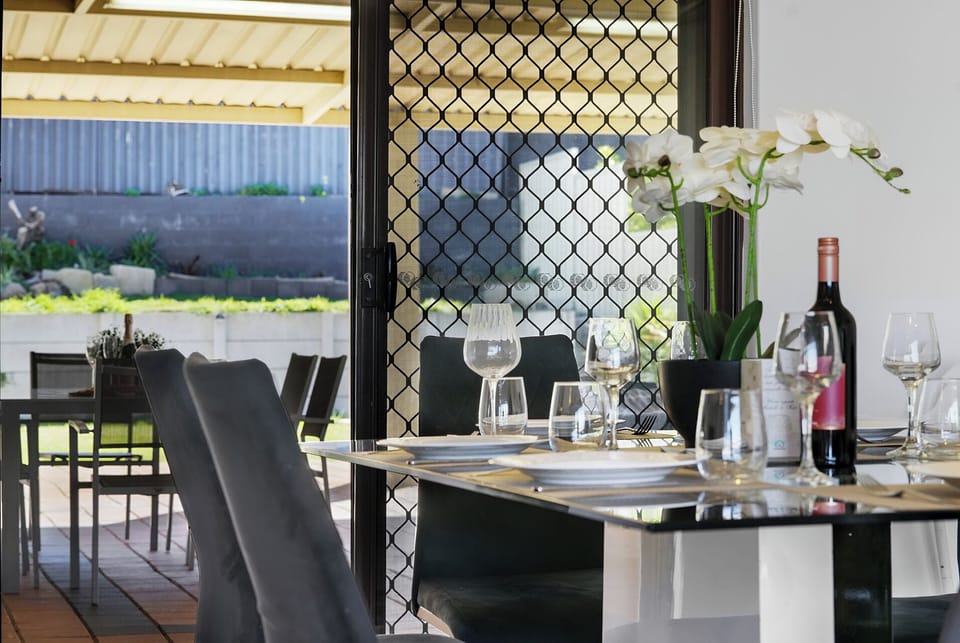 Indoor dining area with views of the outdoor entertaining space