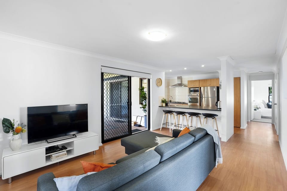 Open living space connecting the lounge, kitchen, and alfresco area