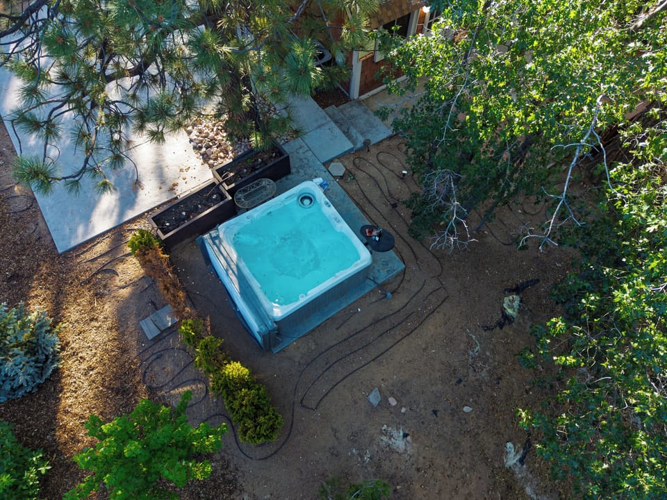 Aerial top-down view showing the hot tub, deck, and property layout.