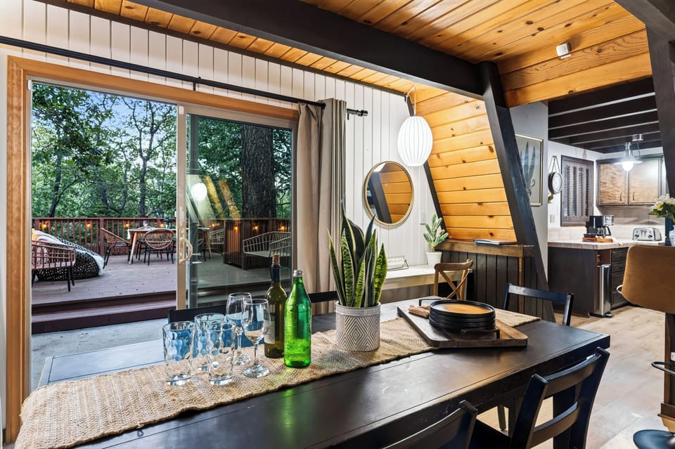 Indoor dining area adjacent to large windows overlooking nature.