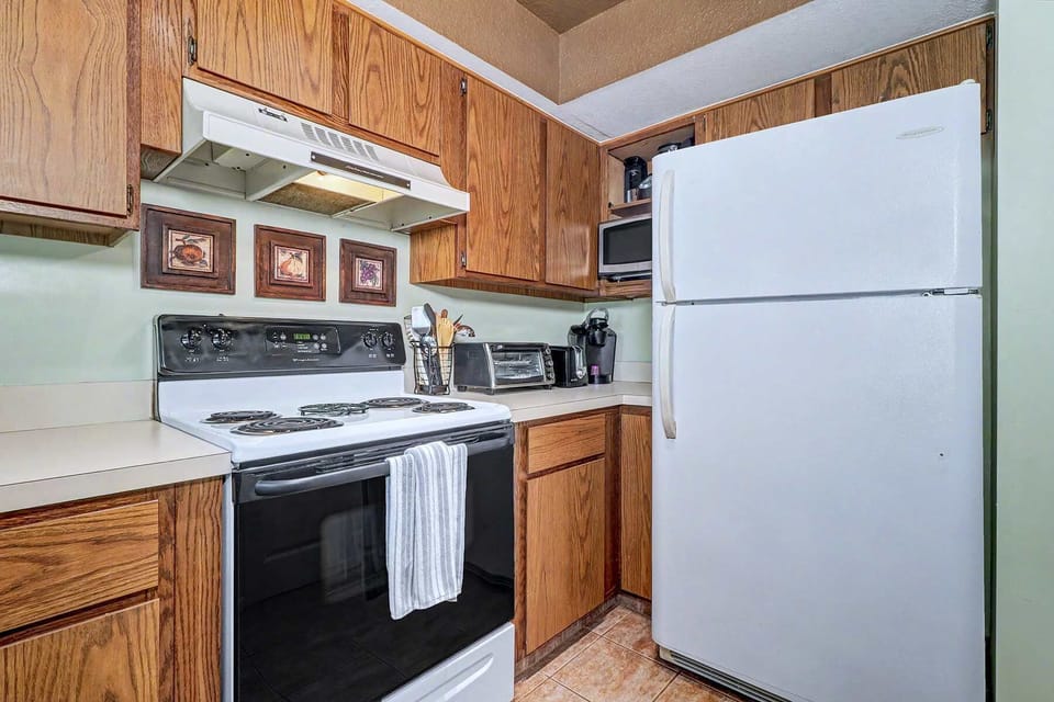 The morning workhorses. Keurig on the counter for your first cup, toaster oven for a quick breakfast, and a full-size fridge waiting to be stocked.