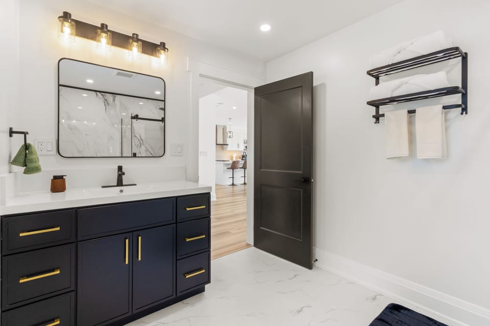 Another view of the stylish bathroom showcasing its modern vanity and bright design.