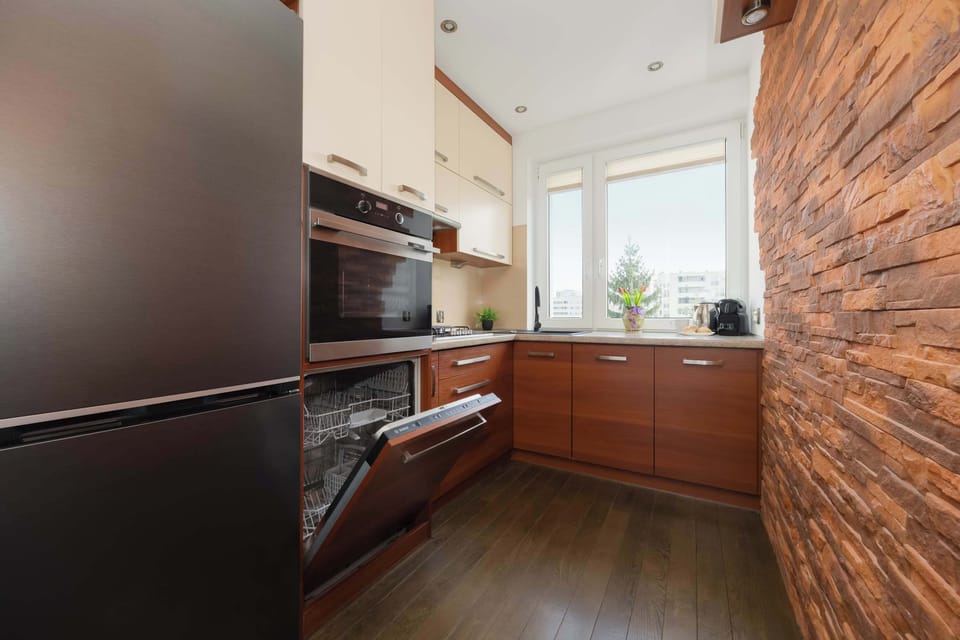 Spacious kitchen with a large refrigerator, generous worktops, and contemporary finishes.