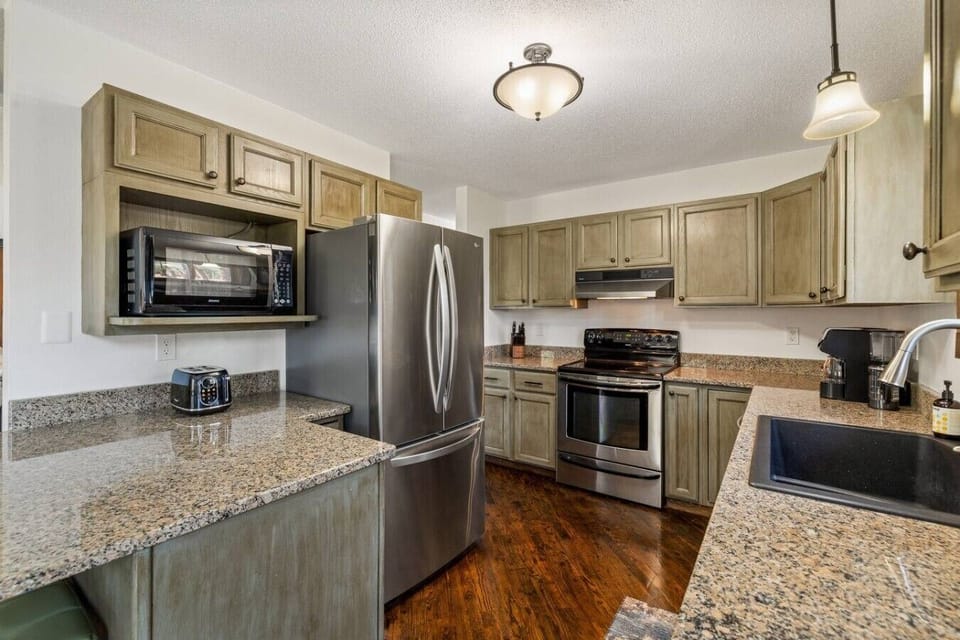 The fully equipped kitchen includes a microwave, toaster, coffee maker, stove, and all the essential kitchen materials needed for a convenient and enjoyable stay.