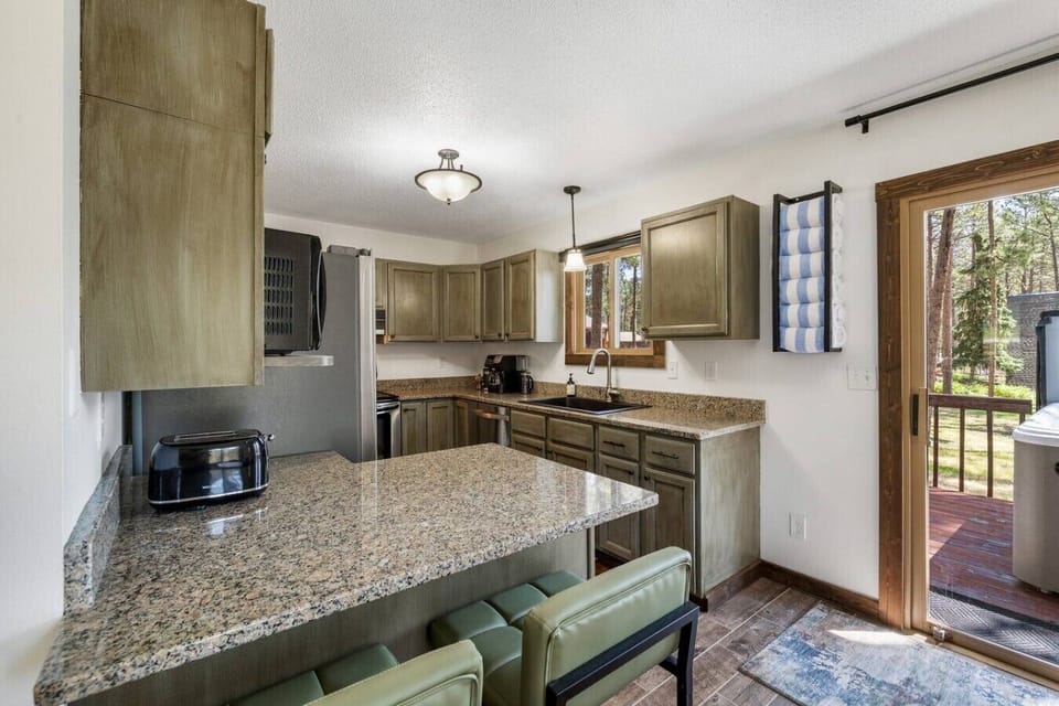 The kitchen features a stylish design with a spacious island, creating a warm and inviting space perfect for cooking, gathering, and enjoying meals together.
