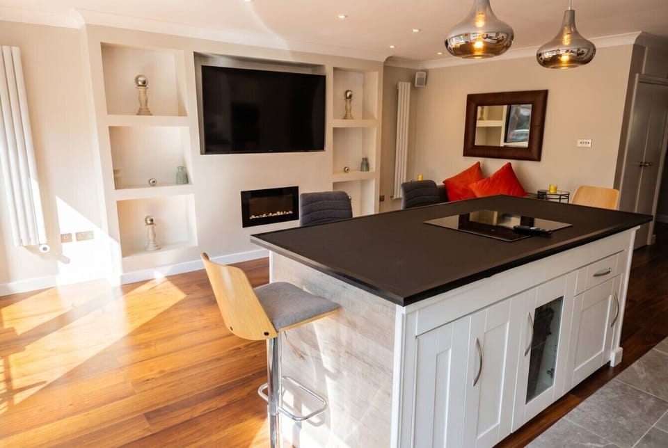 Stylish island and built-in fire make this the heart of the home