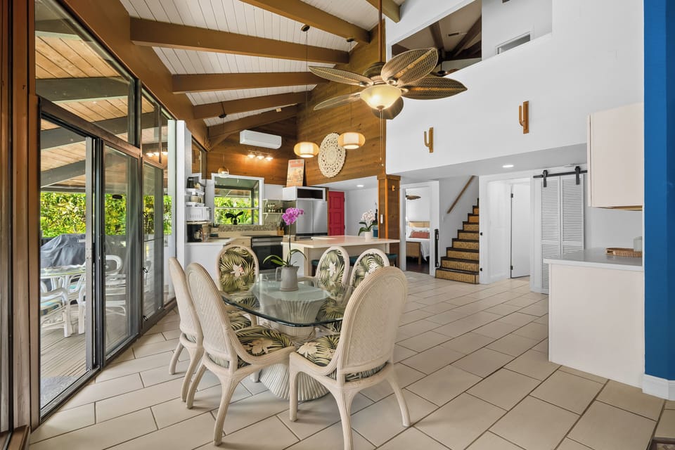 Gather around glass and rattan while the open kitchen keeps everyone in on dinner.