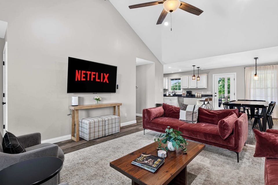 Living Room: A cozy living room designed for relaxing, with comfortable seating, warm touches, and an inviting atmosphere perfect for unwinding after a day out.