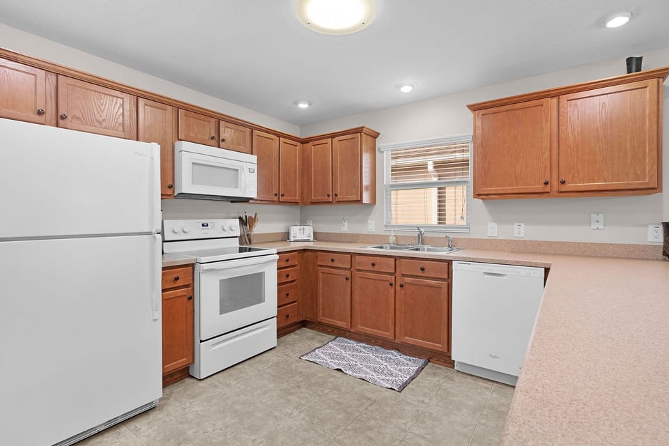 Your fully-equipped kitchen features warm wood cabinetry, generous counter space, and all the appliances you need to whip up meals, making it easy to feel right at home.
