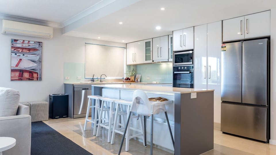 Spacious kitchen featuring a breakfast bar and quality appliances.