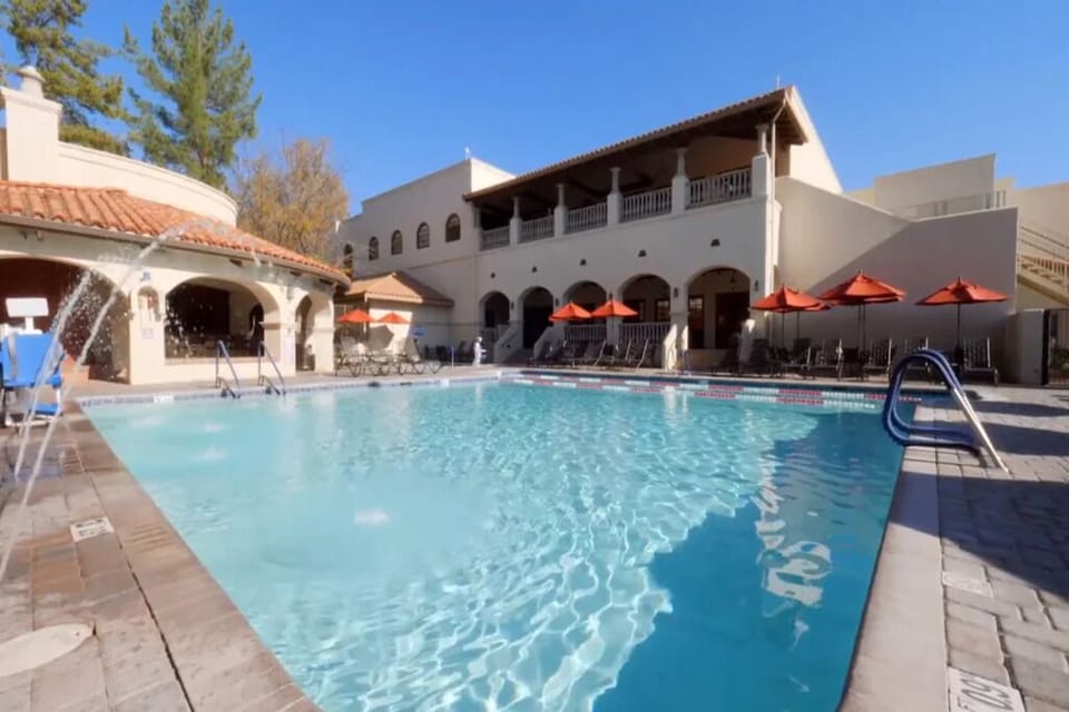 Dive into sparkling blue water under sunny courtyard skies.