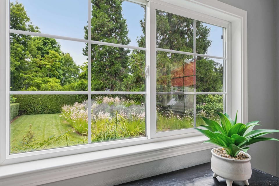 Framed by lush greenery and mature trees.