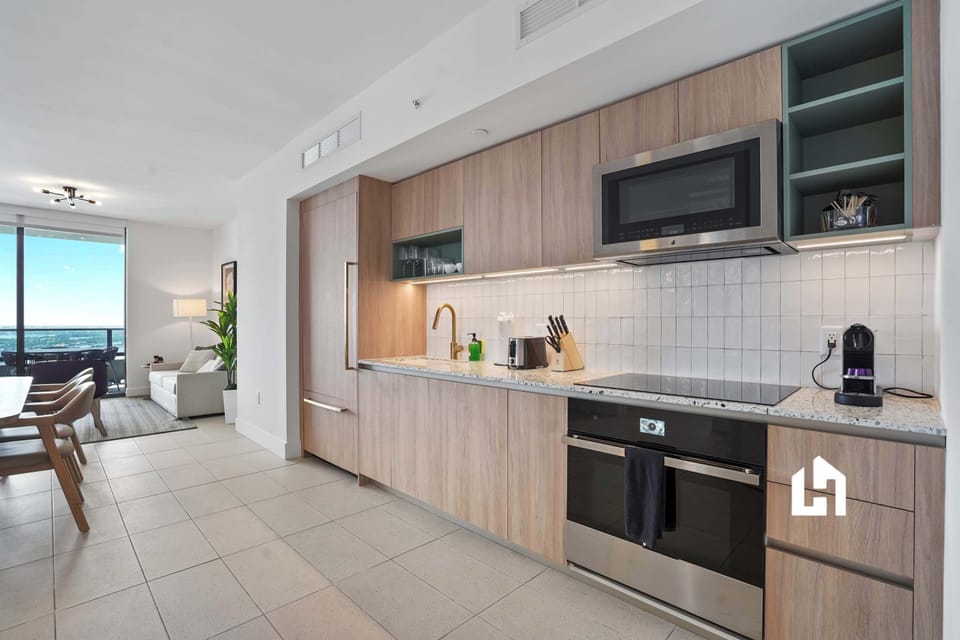 Fully equipped kitchen with modern appliances and cookware.