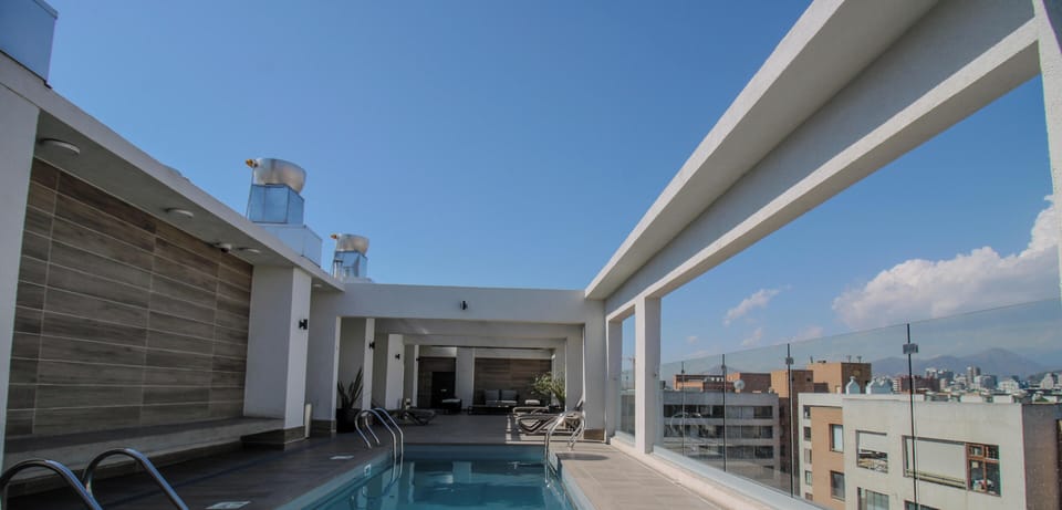 Modern rooftop pool with lounge area and sweeping city views