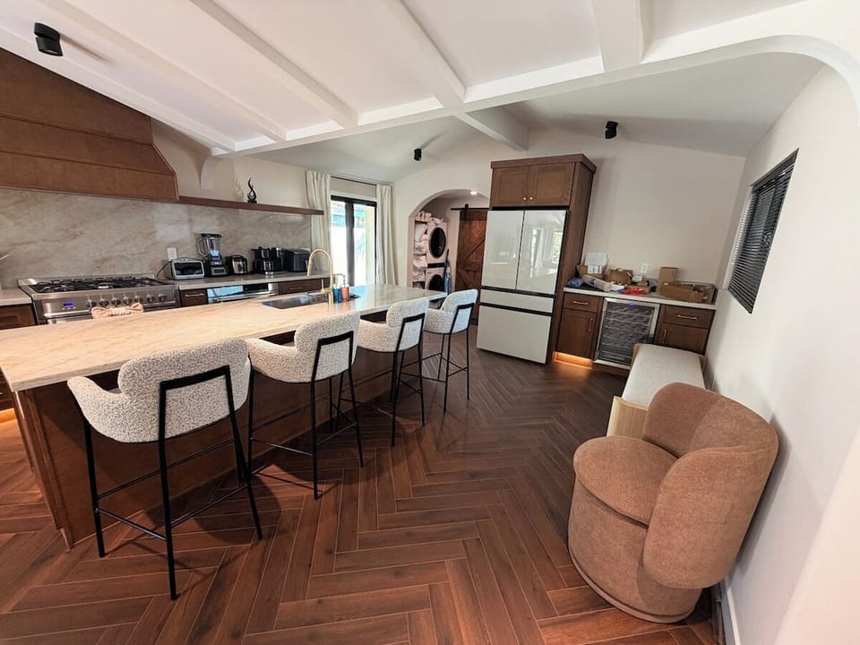 Enjoy the ultimate blend of style and function in this modern kitchen, anchored by a large central island perfect for food preparation and morning coffee.