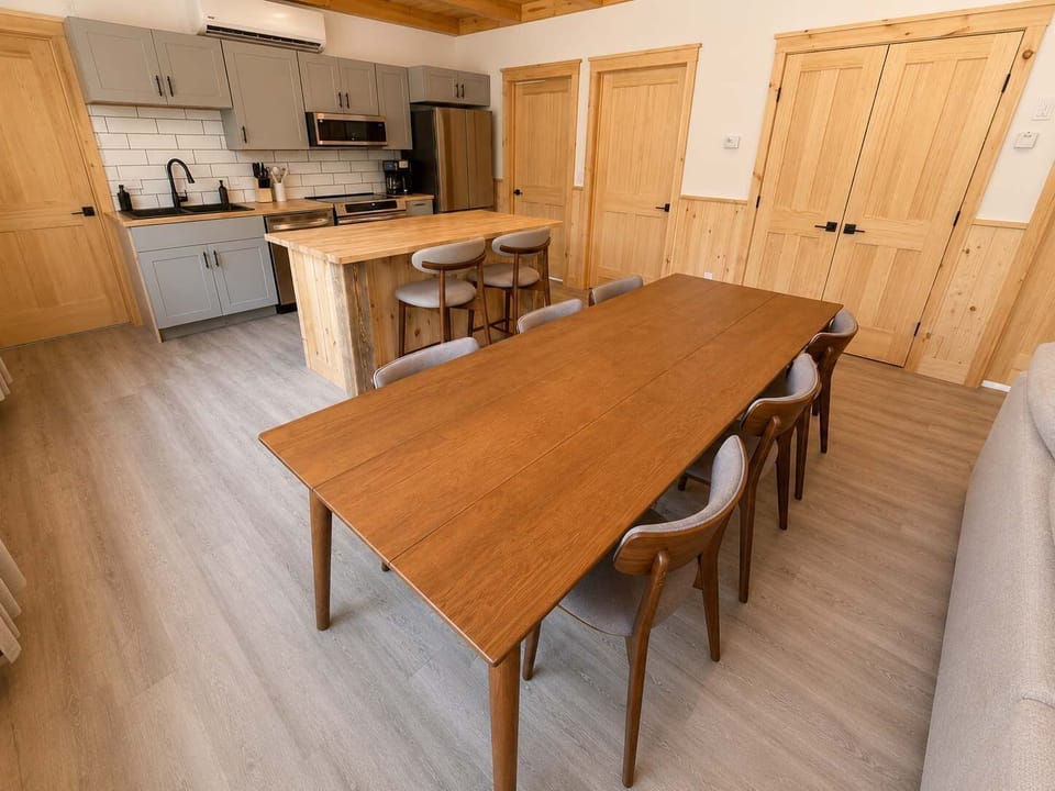 Dining Area: Gather in a bright kitchen and dining area with modern appliances, ample counter space, and a comfortable table for sharing meals, coffee, and conversation.