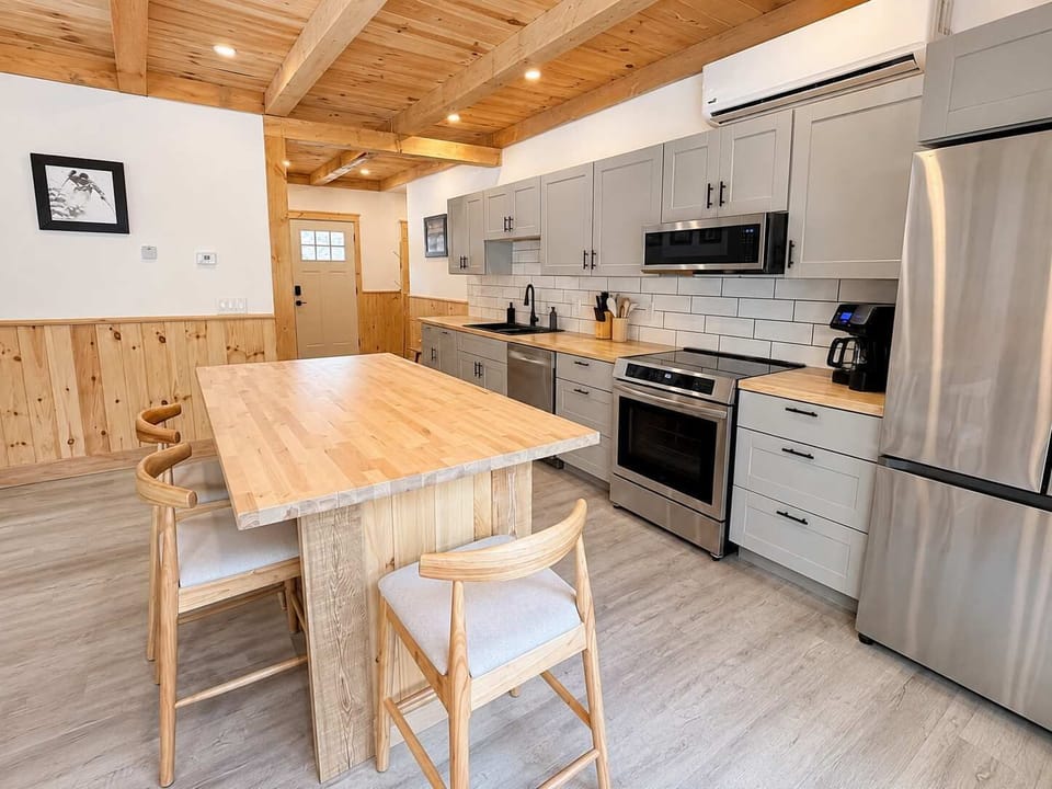 Dining Area: Gather in a bright kitchen and dining area with modern appliances, ample counter space, and a comfortable table for sharing meals, coffee, and conversation.