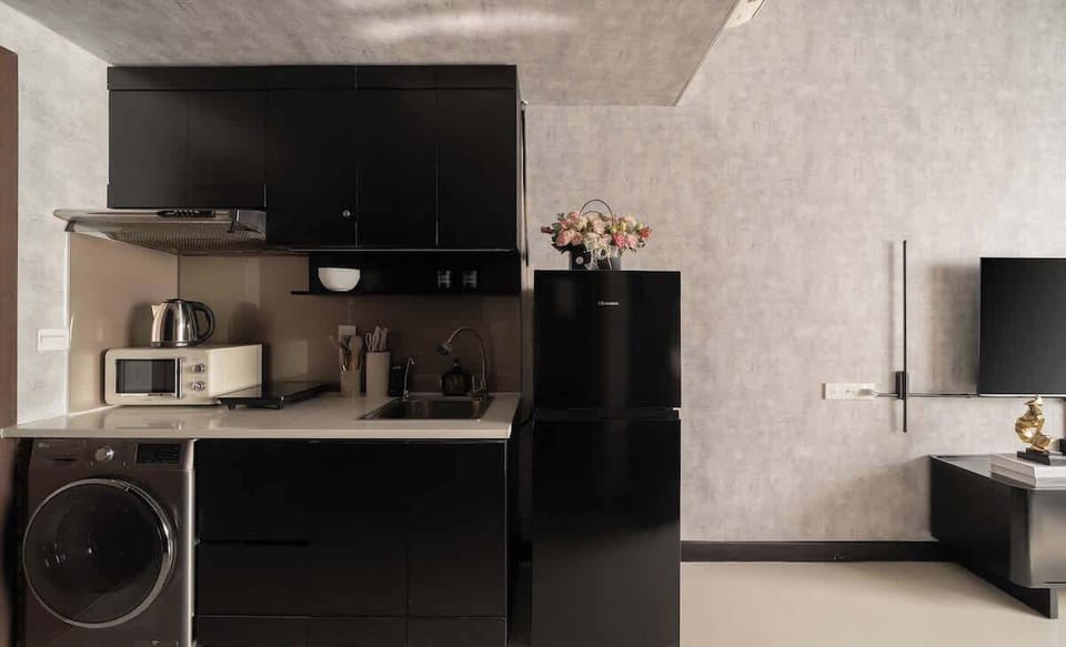 Enjoy a full, modern kitchen with a microwave, electric stove, utensils, and fridge. Beer cups and wine glasses are provided. The 10kg washer/6kg dryer combo is ideal for any trip length, ensuring great convenience during your stay.