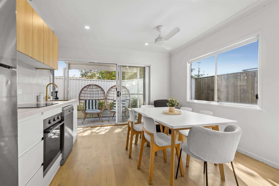 "Fully equipped kitchen with a large fridge, oven, and dishwasher, plus an adjoining dining area — everything you need to cook and relax."