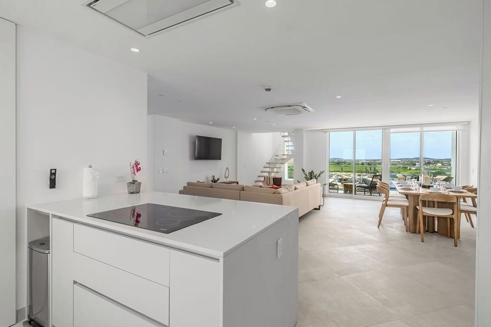 Picture yourself in this bright, open-concept space where sleek modern design meets relaxed coastal living. You'll enjoy panoramic views stretching across the landscape while you cook, dine, or unwind.