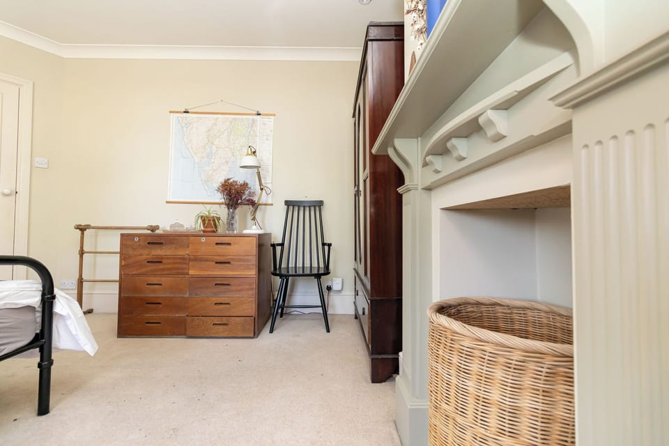 Charming bedroom with decorative fireplace and vintage-style furnishings