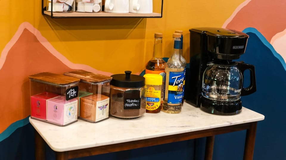 Start your mornings with everything you need for a perfect cup of coffee, complete with flavored syrups and fresh supplies neatly arranged and ready to go.