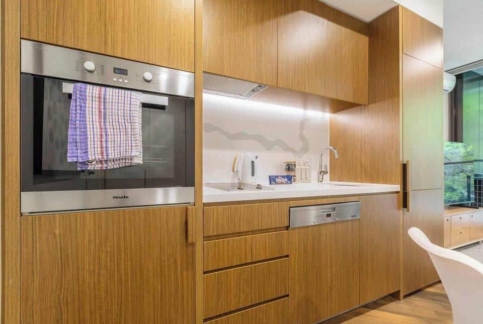 The kitchen includes an oven, Nespresso machine, pour-over coffee set, dishwasher, microwave, toaster, kettle, fridge, and all the cookware needed for easy meals at home.