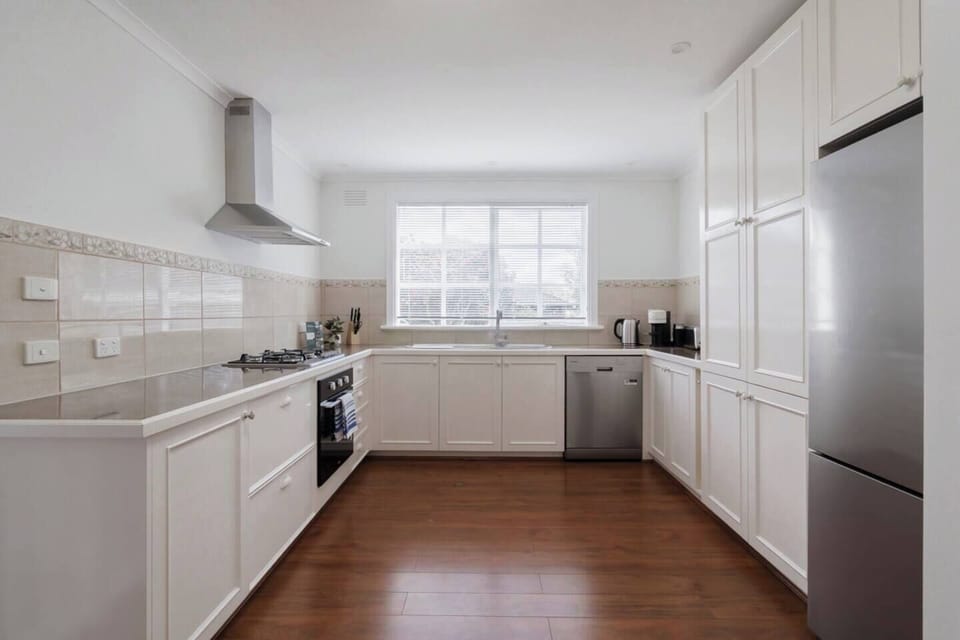 Whip up delicious meals in the fully equipped kitchen, complete with generous bench space, a gas cooktop, an oven, and ample cabinetry for all your essentials.