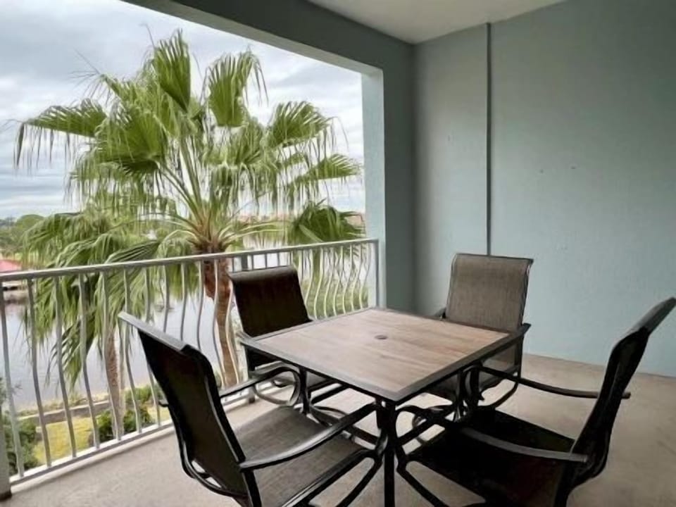 Balcony table and chairs with palms on either side — golden-hour views over the Intracoastal