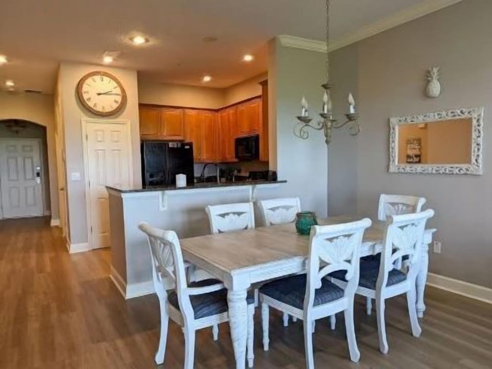 Dining area with coastal decor and warm overhead lighting
