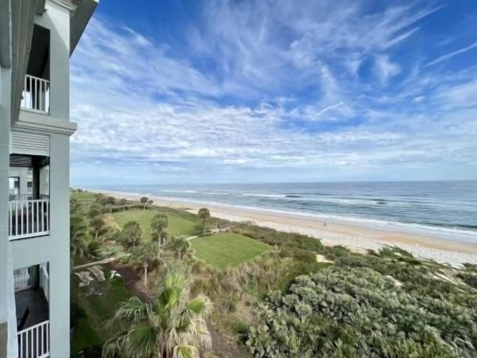 Open ocean view from the balcony — waves and horizon visible from the outdoor seating