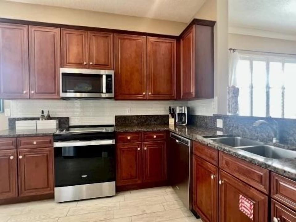 Kitchen with granite counters, stainless steel appliances, and room for the whole group to cook