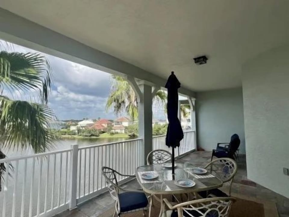 Private balcony with table and chairs overlooking the lake — morning coffee with a view