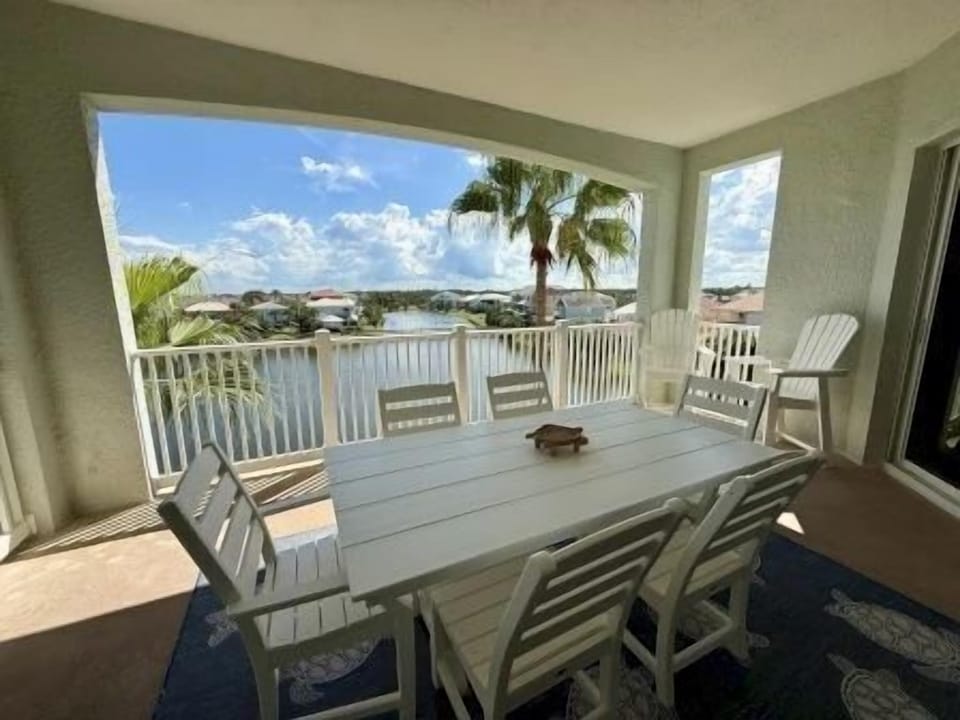 Balcony table with two chairs and lake views on all sides — a good spot morning or evening