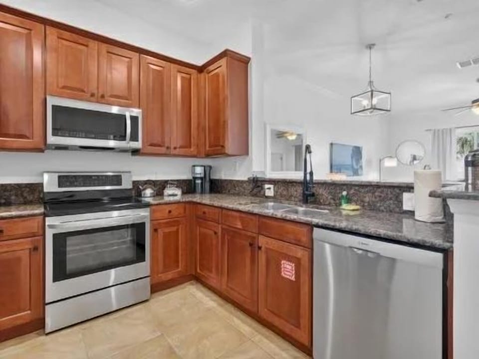 Kitchen with rich cabinetry, stainless steel appliances, and counter space for full meal prep
