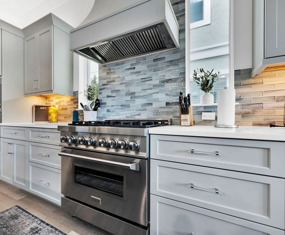 Kitchen with high-end cabinetry, stone counters, and full-sized stainless appliances