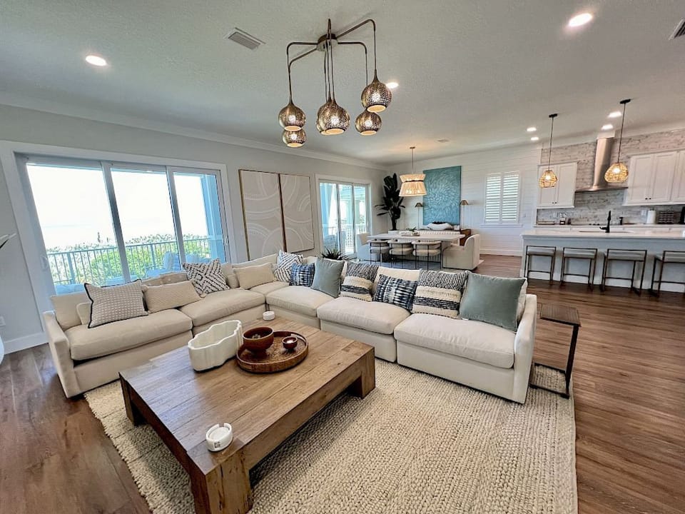 Living area with pull-out queen sofa, artisan furnishings, and ocean views through large windows