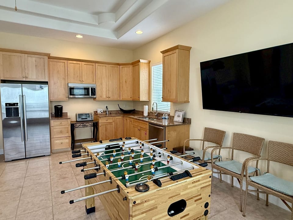 Game room with foosball table, built-in cabinetry, and a kitchenette — its own separate space