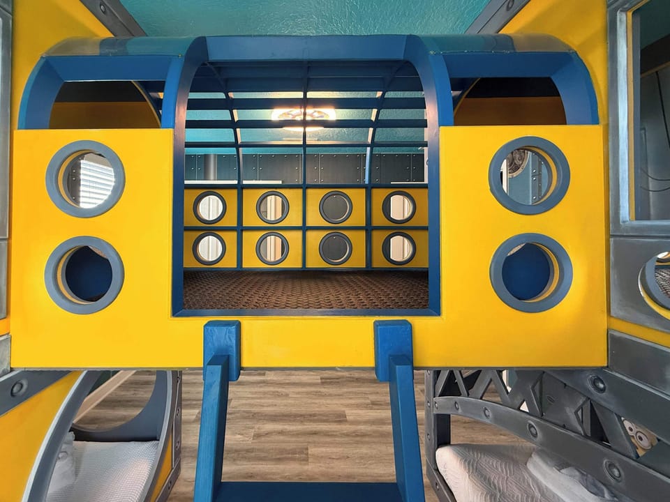 The Banana Minions Room (Sleeps 4).  A bright and playful Minions-inspired world featuring: 🛏️ 2 custom bunk beds. This room feels like stepping directly into the Minions universe.