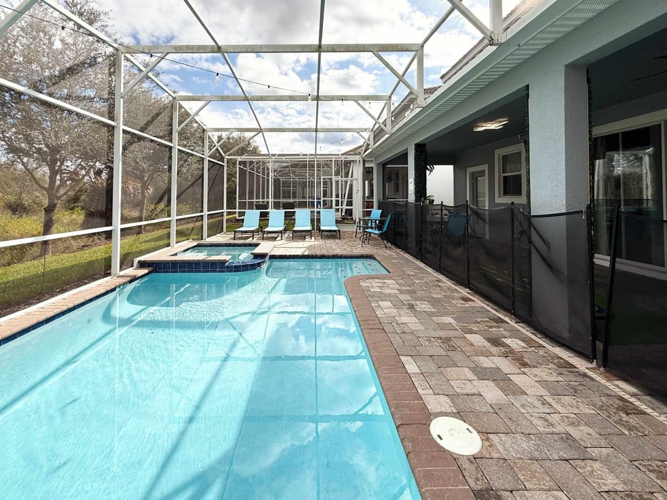 Step outside into your private screened pool oasis. 

Enjoy:
🏊 Private heated pool & spa
☀️ Comfortable lounge chairs
🍽️ Outdoor dining area
🌴 Relaxing covered patio space

Perfect for sunny pool days, evening swims, or relaxing after the parks.