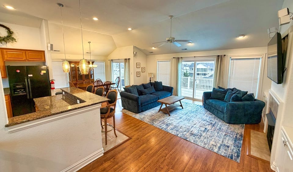 Bright open living with balcony, granite kitchen & fireplace