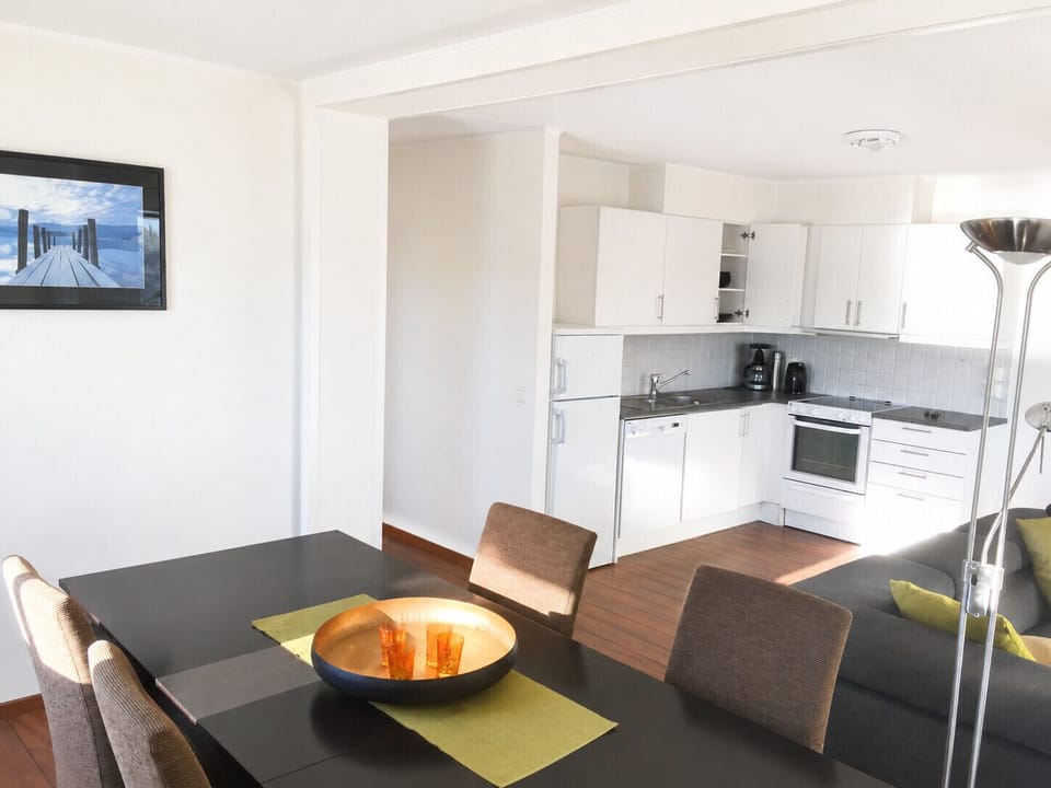 Fully equipped kitchen with cooking essentials and comfortable dining space with seating for the whole family.