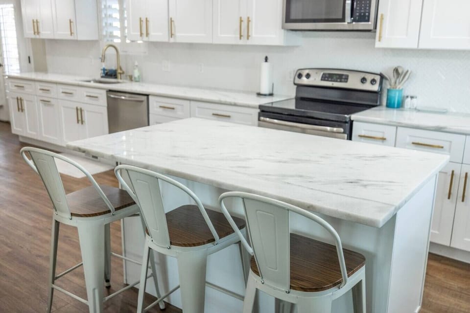 Bright kitchen island with comfortable bar seating and generous prep space