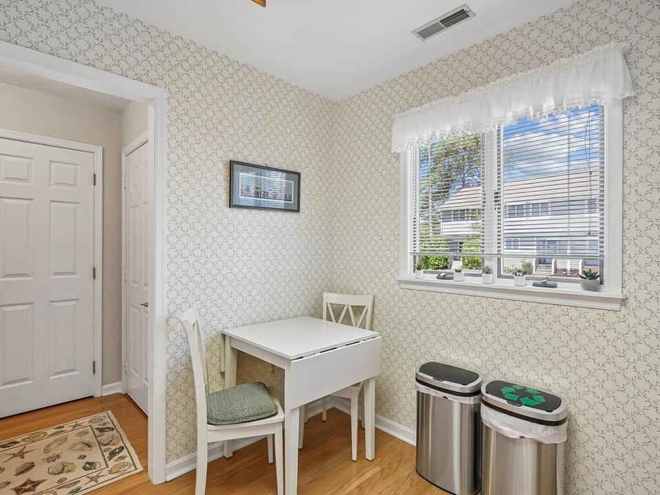 Compact dining nook with drop-leaf table and window overlooking the porch -- seats two for a quick breakfast