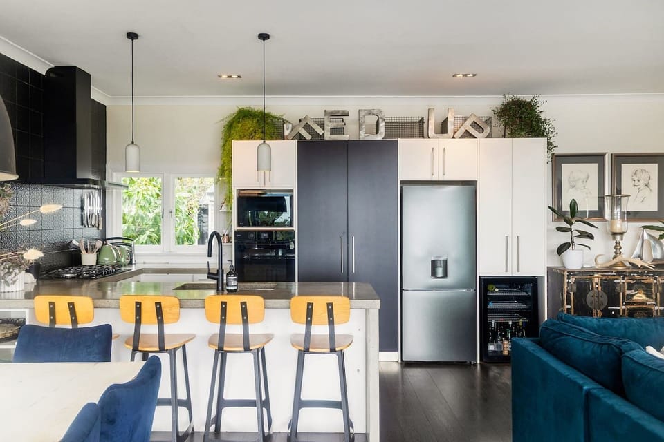 Fully equipped kitchen complete with bar seating and wine fridge