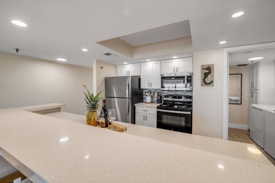 Bright and airy, this updated kitchen features stainless steel appliances, modern finishes, and a fresh coastal feel that makes the space both stylish and inviting