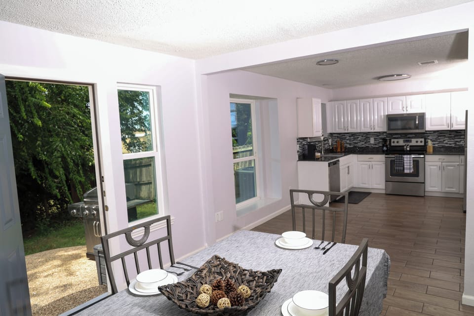 Bright open kitchen and dining area with patio access