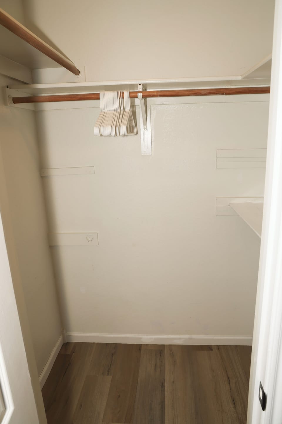 Spacious walk-in closet with hangers and convenient storage space