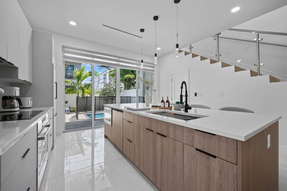 Bright dining area with wooden table and sleek contemporary chairs.