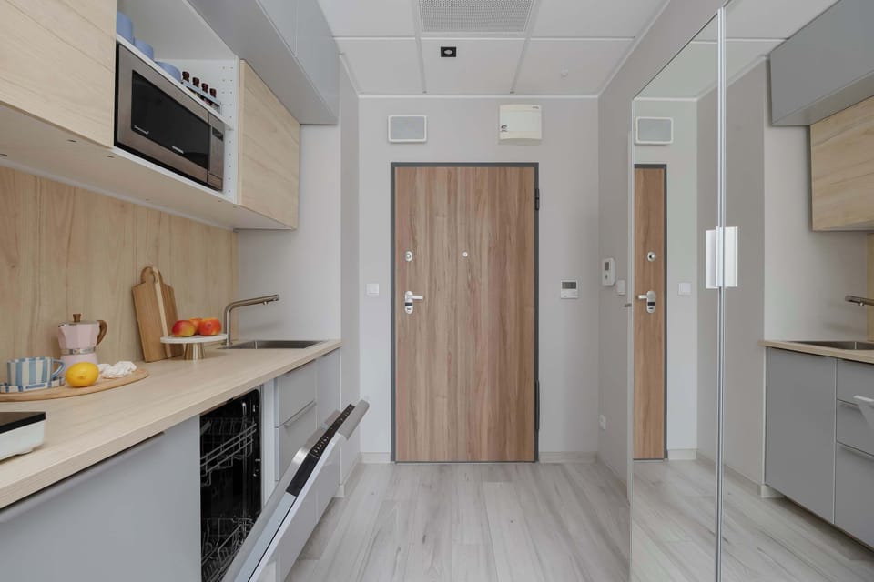 Kitchen worktop with sink, induction hob, and contemporary wooden finishes.